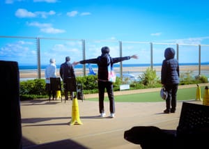 People waving goodbye at planes in Beppu